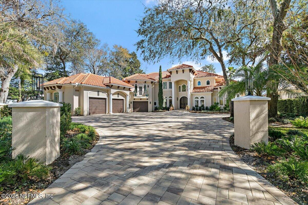 Coastal Florida home with palm trees and manicured lawn